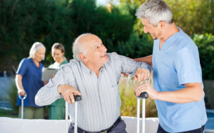 caregiver assisting old man